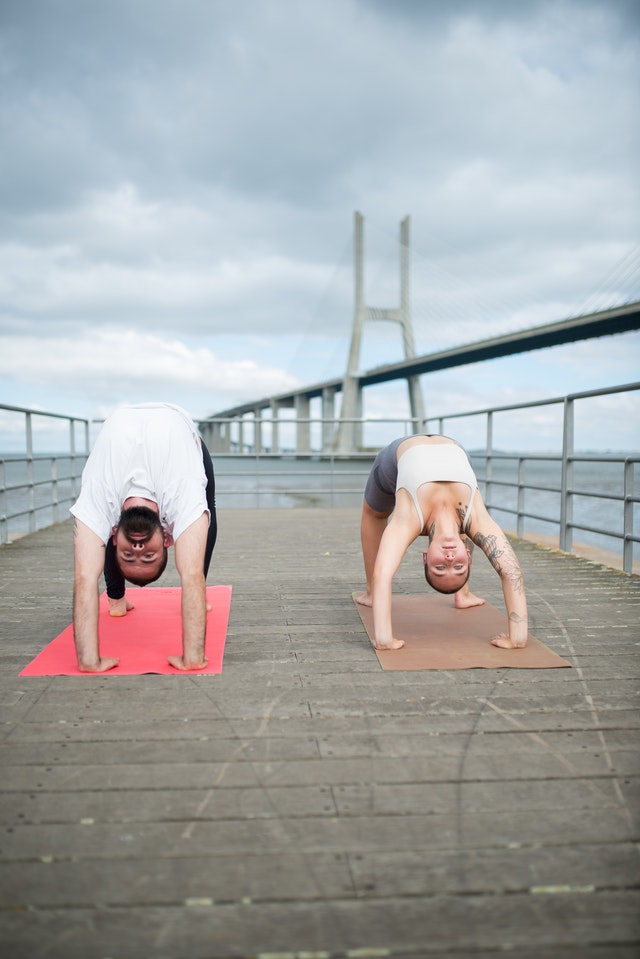 Pose for couples Setu Bandha Sarvangasana (Bridge Pose) and Wind Relieving Pose