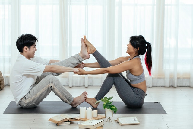 The Boat Pose for Couples, also called Paripurna Navasana